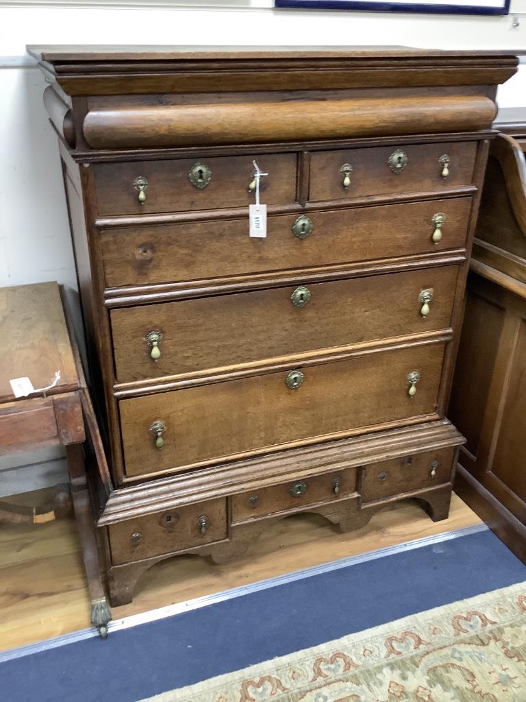 An 18th century oak chest on stand, width 105cm, depth 56cm, height 134cm